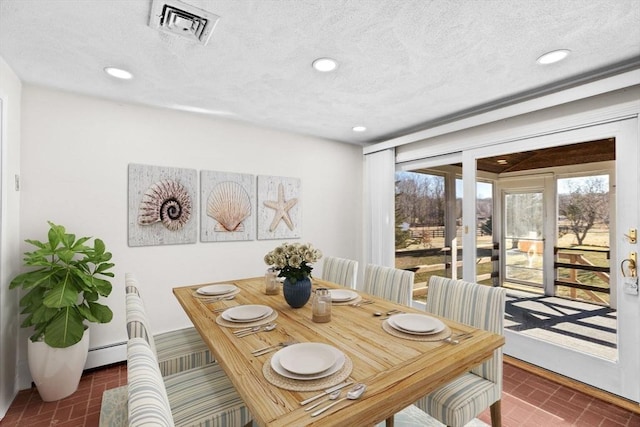 dining space featuring a textured ceiling