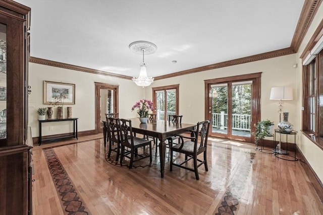 72 Charlemont St, Newton, MA 02461 - dining area featuring wood-type flooring, a chandelier, crown molding, and baseboards