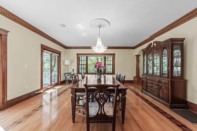72 Charlemont St, Newton, MA 02461 - dining area with light wood finished floors, a chandelier, baseboards, and crown molding