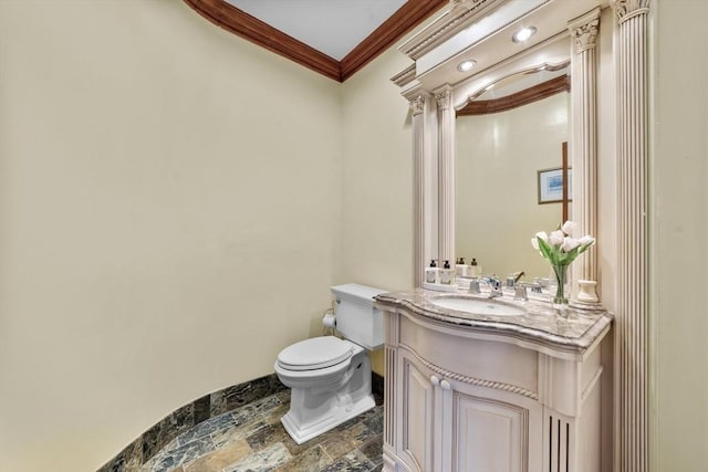 72 Charlemont St, Newton, MA 02461 - half bathroom featuring stone tile floors, ornamental molding, toilet, and vanity