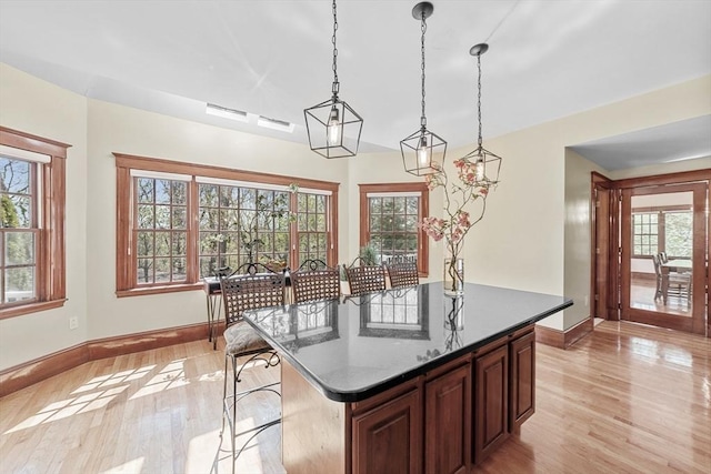 72 Charlemont St, Newton, MA 02461 - kitchen with baseboards, light wood-type flooring, healthy amount of natural light, and a kitchen island