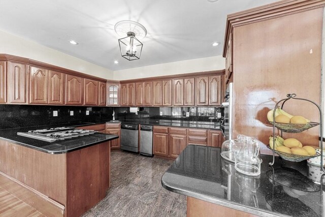 72 Charlemont St, Newton, MA 02461 - kitchen with appliances with stainless steel finishes, a peninsula, decorative backsplash, glass insert cabinets, and dark stone counters