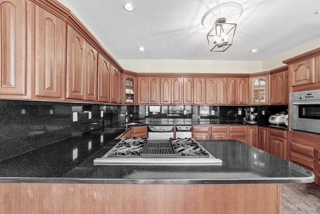 72 Charlemont St, Newton, MA 02461 - kitchen with appliances with stainless steel finishes, glass insert cabinets, tasteful backsplash, a sink, and recessed lighting