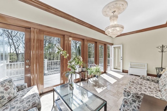 72 Charlemont St, Newton, MA 02461 - living room featuring baseboards, a chandelier, crown molding, and stone tile floors