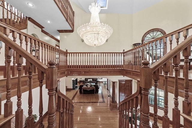 72 Charlemont St, Newton, MA 02461 - staircase with a towering ceiling, a chandelier, wood finished floors, and recessed lighting