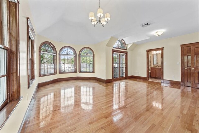 72 Charlemont St, Newton, MA 02461 - unfurnished living room with vaulted ceiling, a chandelier, light wood finished floors, and baseboards