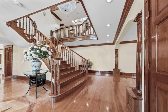 72 Charlemont St, Newton, MA 02461 - staircase with baseboards, wood finished floors, crown molding, a skylight, and recessed lighting