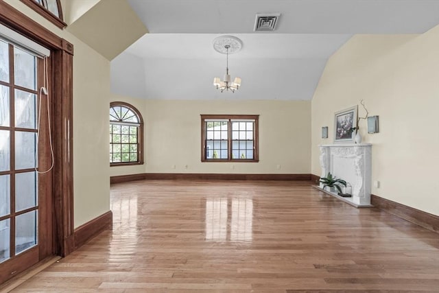 72 Charlemont St, Newton, MA 02461 - unfurnished living room with a chandelier, light wood finished floors, lofted ceiling, baseboards, and a high end fireplace