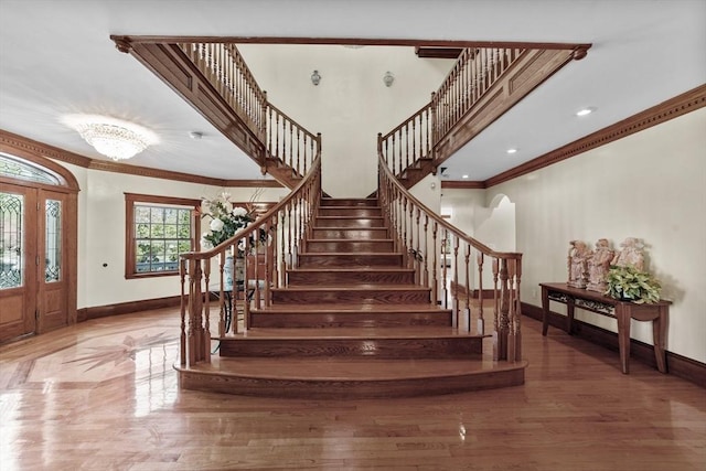72 Charlemont St, Newton, MA 02461 - stairway featuring baseboards, ornamental molding, and wood finished floors