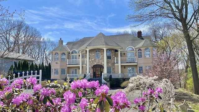 72 Charlemont St, Newton, MA 02461 - view of front facade featuring a balcony, a chimney, and stone siding
