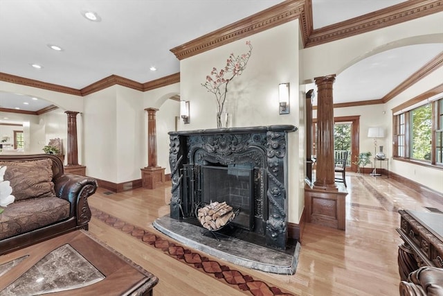 72 Charlemont St, Newton, MA 02461 - living area with ornate columns, crown molding, a fireplace, baseboards, and light wood finished floors