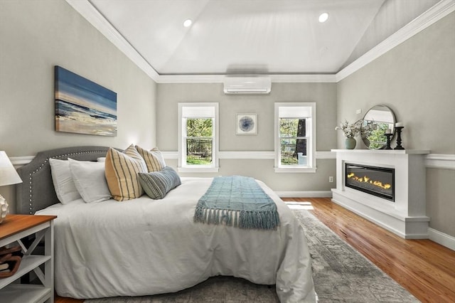 14 Weld St, Westborough, MA 01581 - bedroom featuring an AC wall unit, wood finished floors, a glass covered fireplace, lofted ceiling, and crown molding