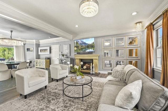 14 Weld St, Westborough, MA 01581 - living room with a chandelier, wood finished floors, recessed lighting, crown molding, and a warm lit fireplace