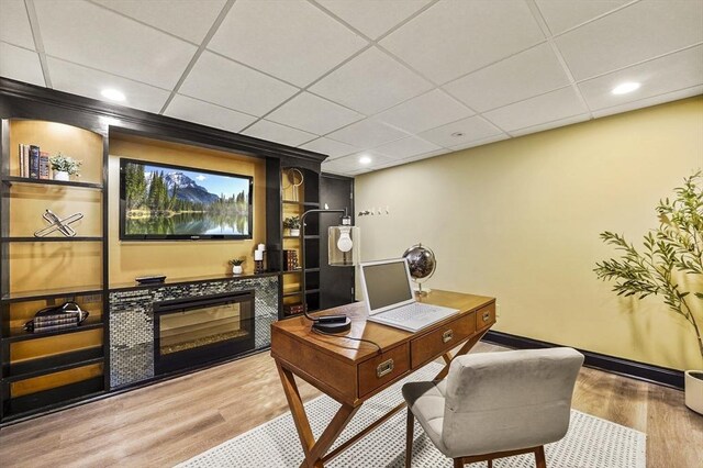 14 Weld St, Westborough, MA 01581 - home office with wood finished floors, baseboards, a glass covered fireplace, a paneled ceiling, and recessed lighting