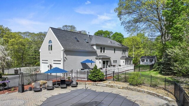 14 Weld St, Westborough, MA 01581 - rear view of property featuring a patio area, an attached garage, a fenced backyard, and a shingled roof