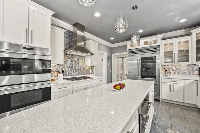 14 Weld St, Westborough, MA 01581 - kitchen featuring wall chimney exhaust hood, stainless steel appliances, tasteful backsplash, ornamental molding, and white cabinetry