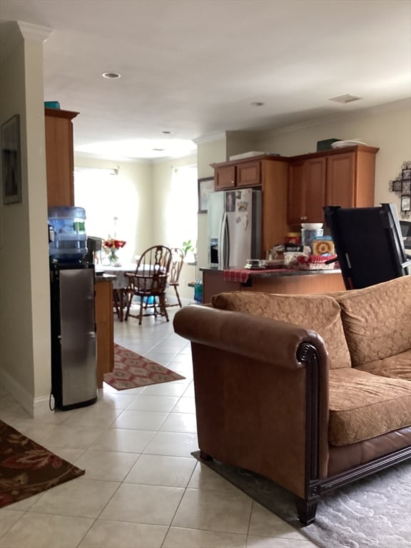 tiled living room featuring crown molding