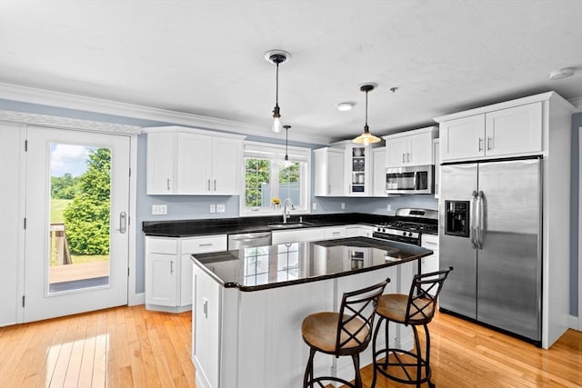 43 N Main St Unit B, Berkley, MA 02779 - kitchen featuring stainless steel appliances, white cabinetry, light wood finished floors, a breakfast bar, and pendant lighting