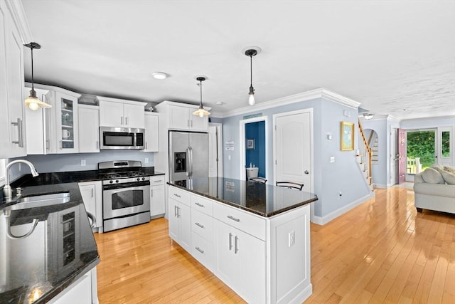 43 N Main St Unit B, Berkley, MA 02779 - kitchen featuring appliances with stainless steel finishes, glass insert cabinets, white cabinets, light wood-style flooring, and crown molding