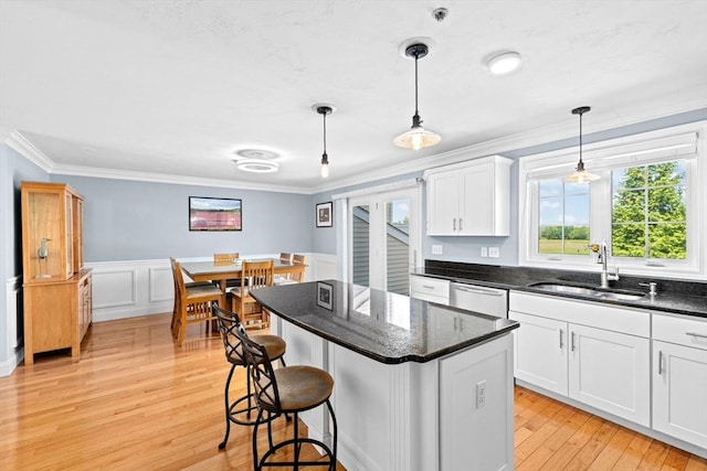 43 N Main St Unit B, Berkley, MA 02779 - kitchen featuring white cabinets, ornamental molding, light wood-type flooring, dishwasher, and wainscoting