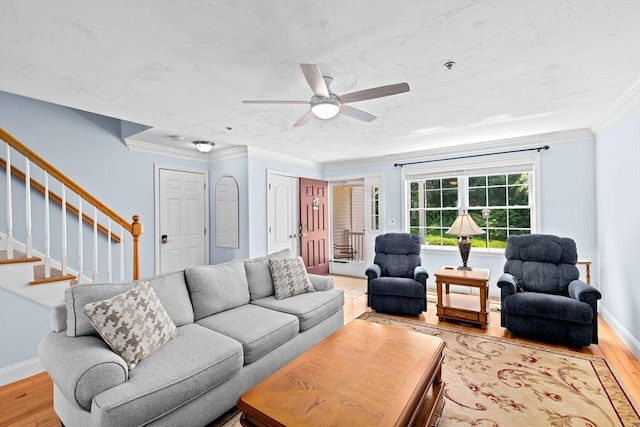 43 N Main St Unit B, Berkley, MA 02779 - living area with light wood finished floors, ceiling fan, stairs, and crown molding