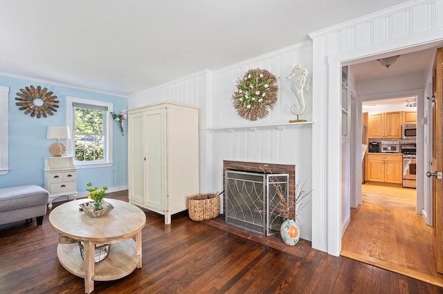 89 W Elm St, Pembroke, MA 02359 - living area with wood-type flooring, a brick fireplace, and ornamental molding