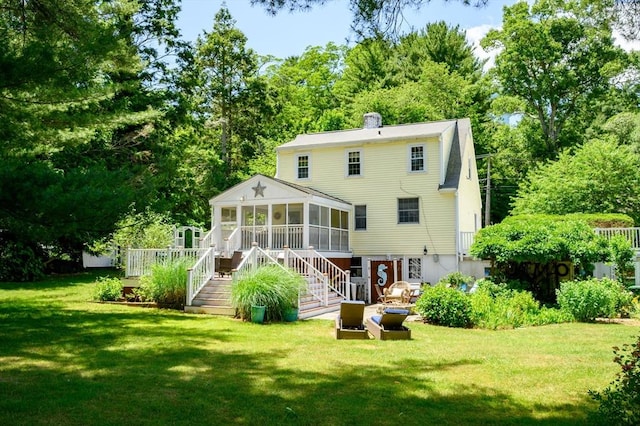 89 W Elm St, Pembroke, MA 02359 - back of house featuring a sunroom, stairway, a lawn, and view of scattered trees