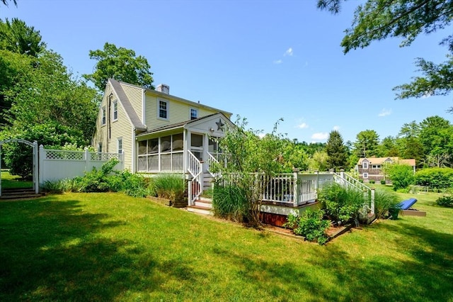 89 W Elm St, Pembroke, MA 02359 - back of property with a sunroom, a chimney, and a deck