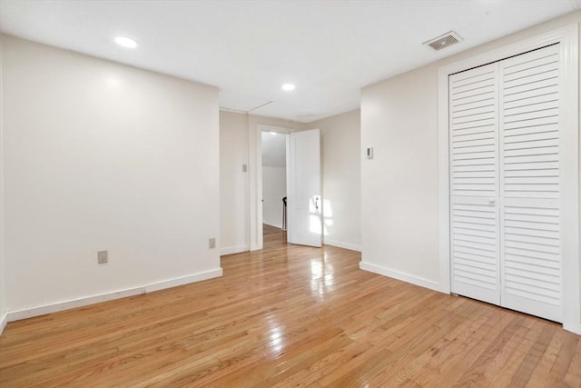 unfurnished bedroom featuring light hardwood / wood-style floors and a closet