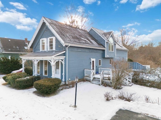 view of snow covered exterior featuring a porch