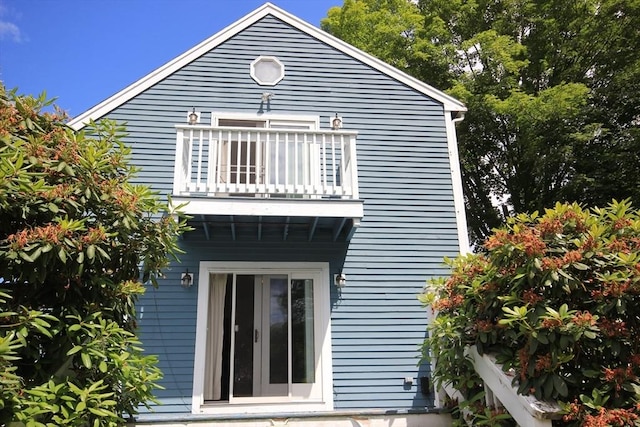 back of property with a balcony