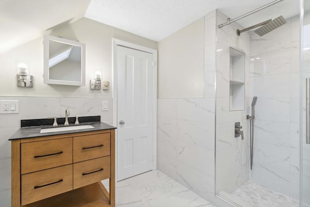 bathroom with vanity, tile walls, and a tile shower