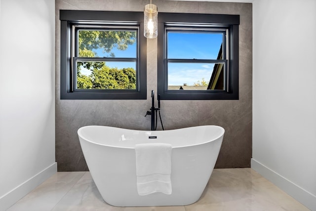 bathroom with a bath and tile walls