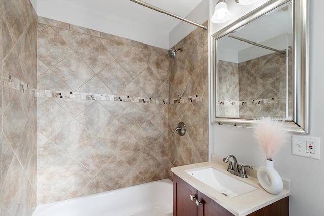 bathroom with tiled shower / bath combo and vanity