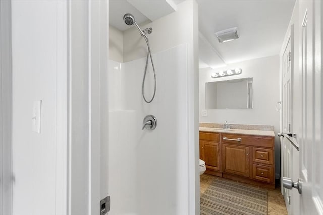 bathroom featuring toilet, tile patterned flooring, vanity, and walk in shower