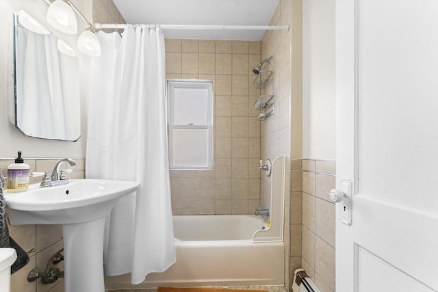 bathroom featuring shower / tub combo with curtain, sink, and baseboard heating