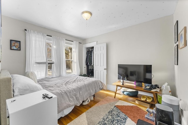 bedroom featuring a closet and light hardwood / wood-style flooring