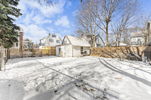 snow covered patio with an outbuilding