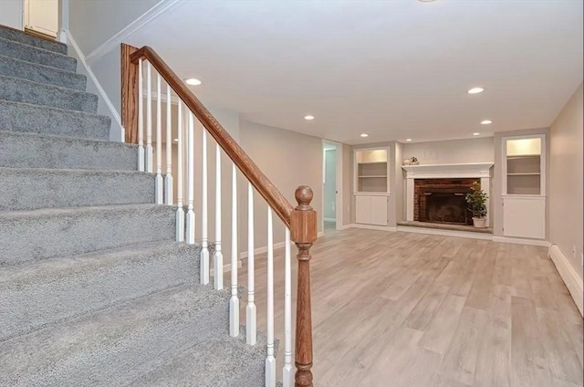 6 Birch Ln, Shrewsbury, MA 01545 - staircase featuring wood finished floors, baseboards, recessed lighting, built in features, and a fireplace