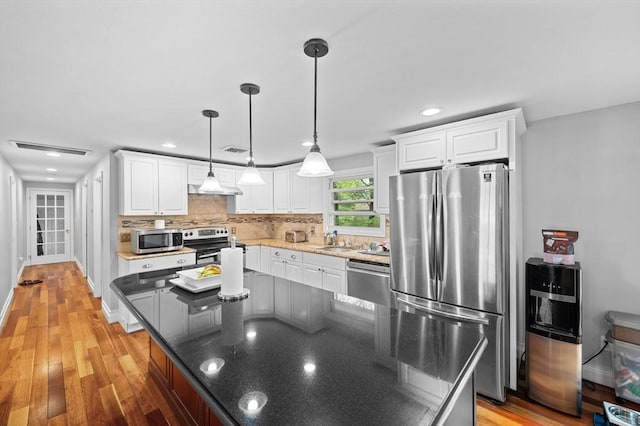 6 Birch Ln, Shrewsbury, MA 01545 - kitchen featuring stainless steel appliances, white cabinetry, backsplash, under cabinet range hood, and recessed lighting