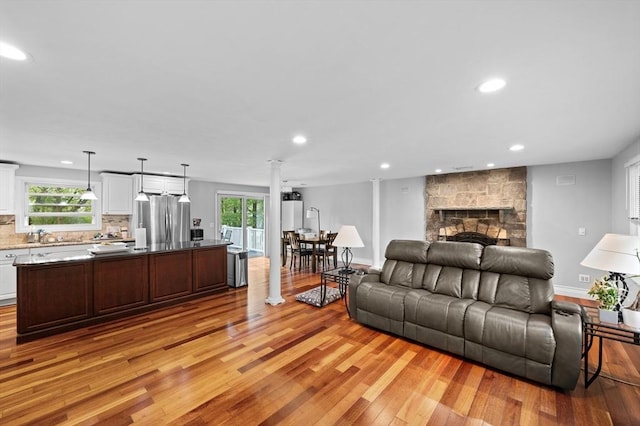 6 Birch Ln, Shrewsbury, MA 01545 - living room featuring light wood-style flooring, recessed lighting, a stone fireplace, and baseboards