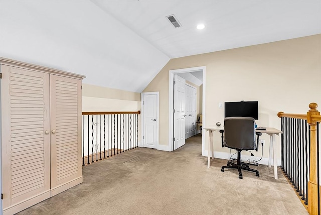 carpeted home office with lofted ceiling, baseboards, and visible vents