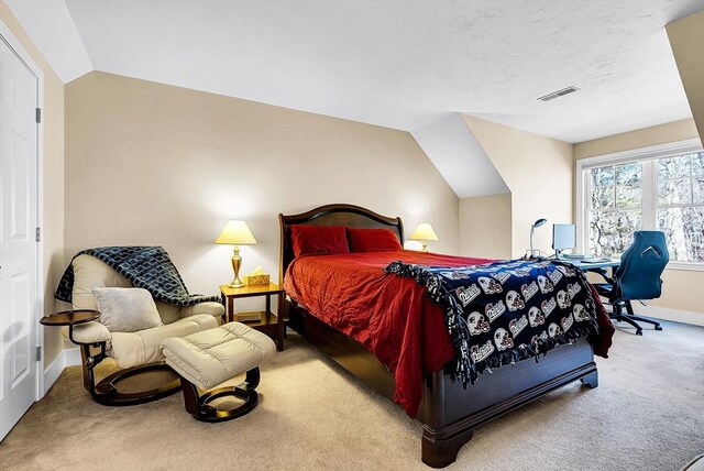 carpeted bedroom featuring vaulted ceiling, visible vents, and baseboards