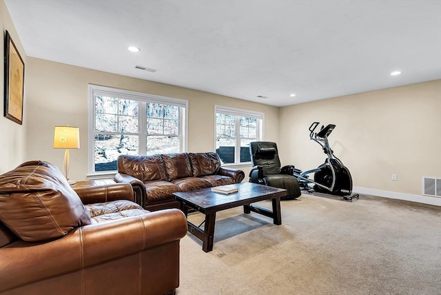 living area featuring light colored carpet, visible vents, baseboards, and recessed lighting