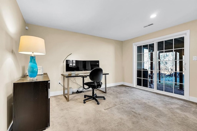 office space featuring carpet floors, visible vents, and baseboards