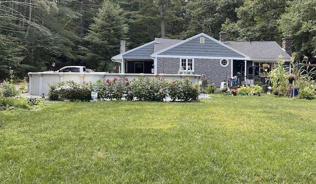 252 Howe St, East Brookfield, MA 01515 - back of house with a chimney, stone siding, and a yard
