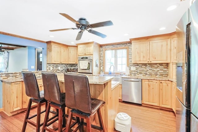 252 Howe St, East Brookfield, MA 01515 - kitchen with stainless steel appliances, light brown cabinets, light wood-style floors, recessed lighting, and ornamental molding