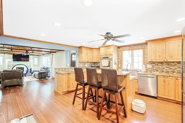 252 Howe St, East Brookfield, MA 01515 - kitchen featuring stainless steel appliances, light brown cabinetry, ornamental molding, open floor plan, and recessed lighting