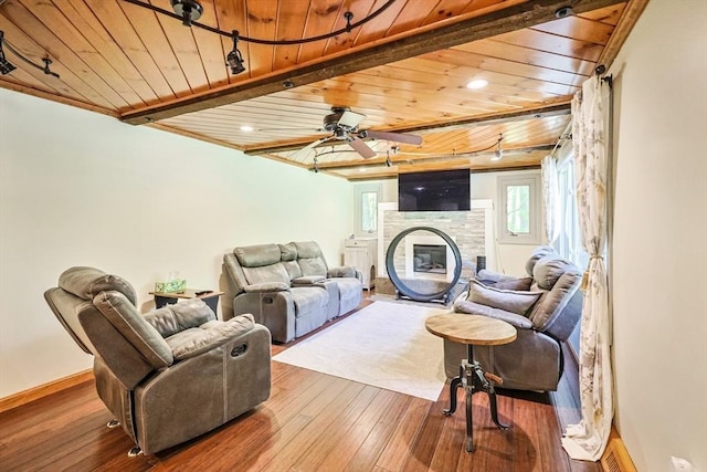 252 Howe St, East Brookfield, MA 01515 - living room featuring wood ceiling, a glass covered fireplace, hardwood / wood-style flooring, baseboards, and a ceiling fan