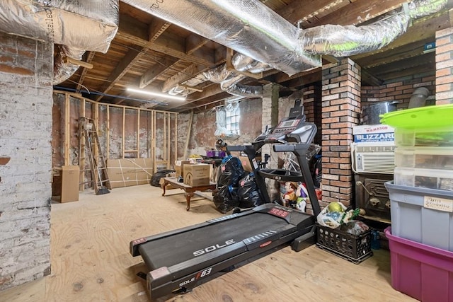 exercise area with brick wall and cooling unit